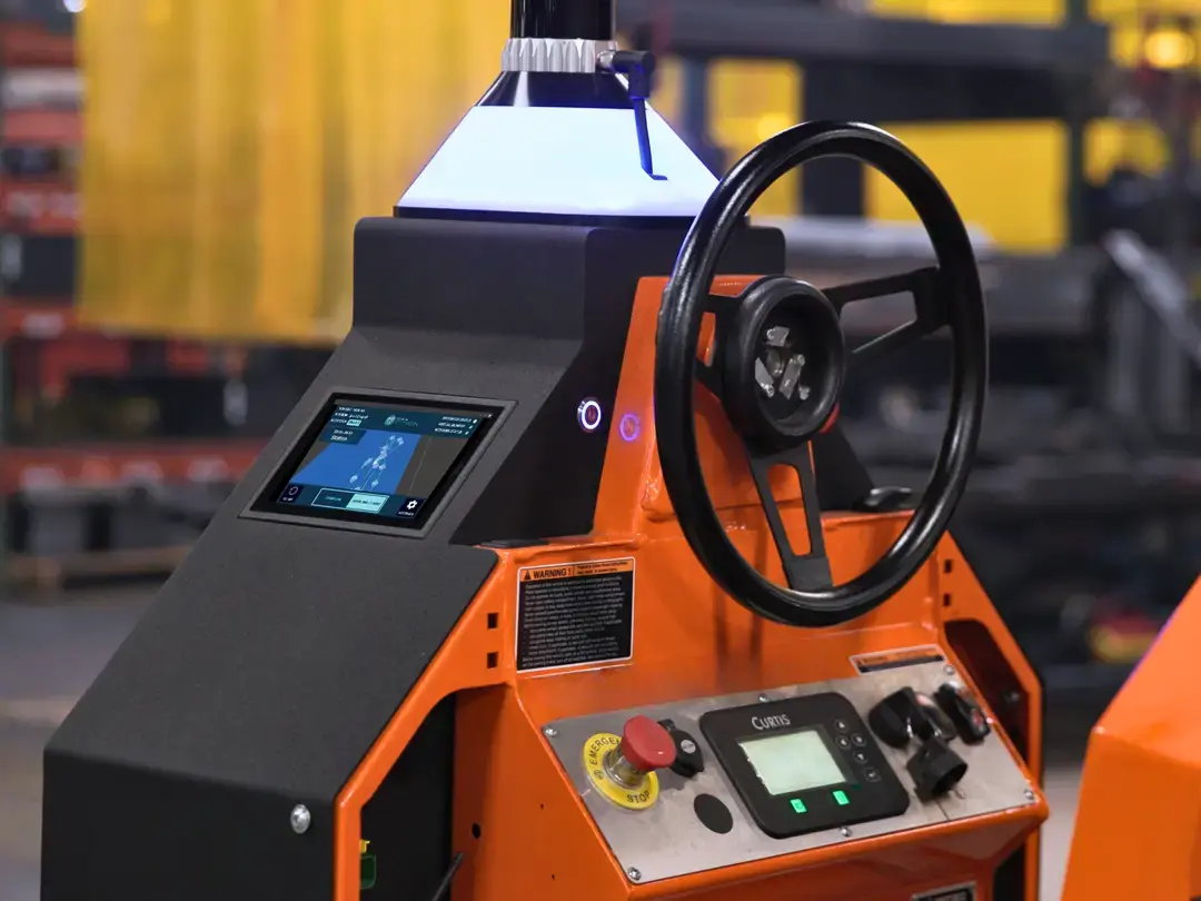 Tugger controls with emergency stop, touchscreen, and safety light